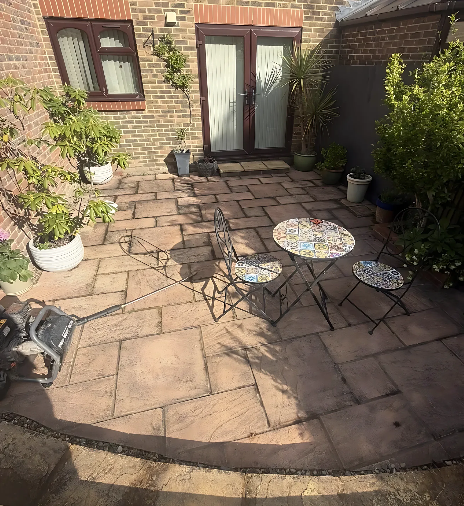 Courtyard patio dark with algae before cleaning