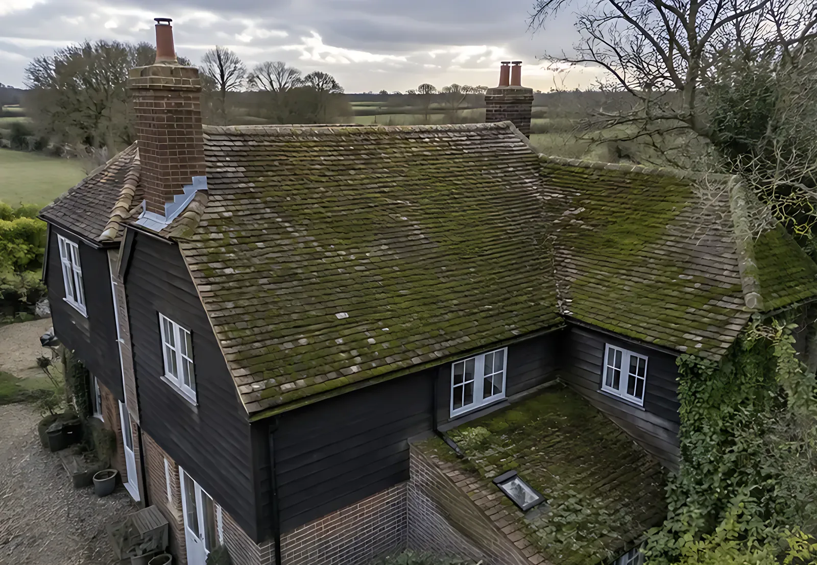 Period farmhouse roof before cleaning